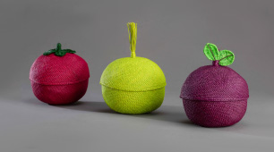 Tres frutos tejidos en palma de iraca. Rojo, verde y púrpura. Imagen promocional de la Convocatoria al Carnaval Artesano 2022 en Pasto, Nariño.